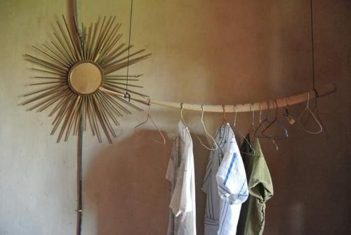 a room with a mirror and a rack with clothes at Nour El Balad in Luxor