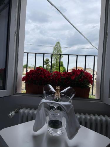 a bathroom sink with a window with flowers in it at Antica Locanda Zio Cesare in Ferrara