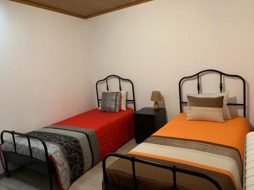 two beds sitting next to each other in a room at Casa do Julien Mountain Experience in Vila Real