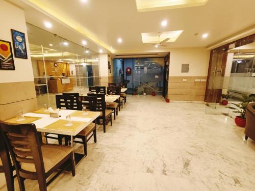 a restaurant with tables and chairs in a room at Mayda Inn- A Boutique Hotel in New Delhi