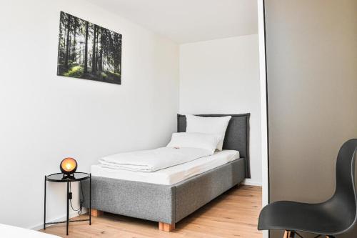 1 dormitorio pequeño con 1 cama y 1 silla en Roblhof, en Drachselsried