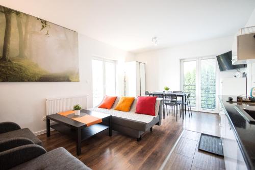 a living room with a couch and a table at Willa Kamilówka in Rabka