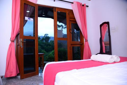 a bedroom with a bed and a large window at Serene Cottage Ella in Ella