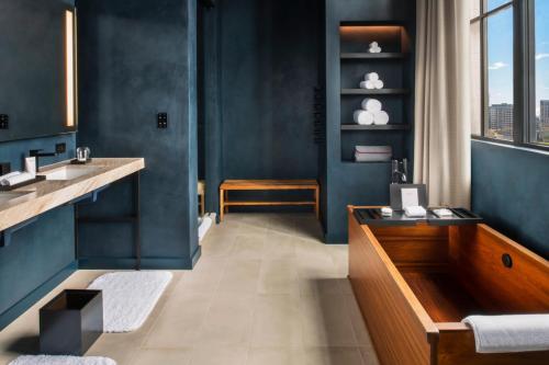 a bathroom with a tub and a sink and a window at Nobu Hotel Chicago in Chicago
