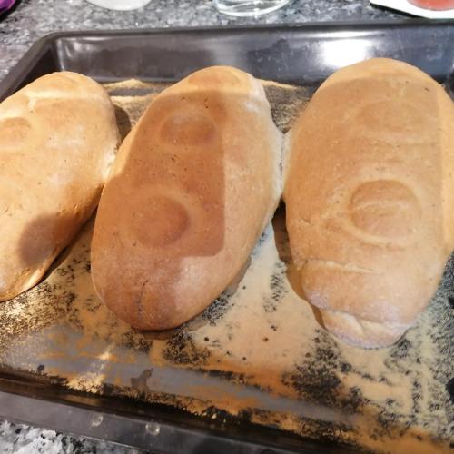 three loaves of bread sitting on top of a pan at Naturhotel Hüttenwirt im Grossarltal in Hüttschlag