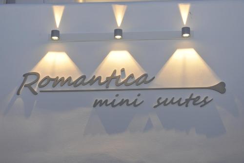 a sign for aulumulum mini suites is shown in a window at Romantica Suites in Naousa