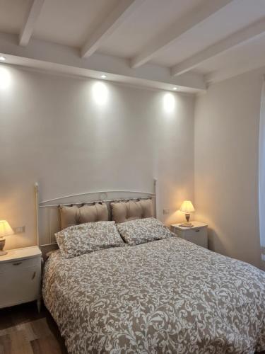 a bedroom with a large bed with two night stands at La casetta del nonno in Capodimonte