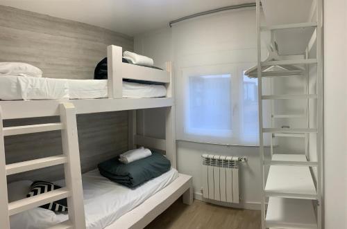 a small room with bunk beds and a window at BPIRINEOS-Benazken in Benasque