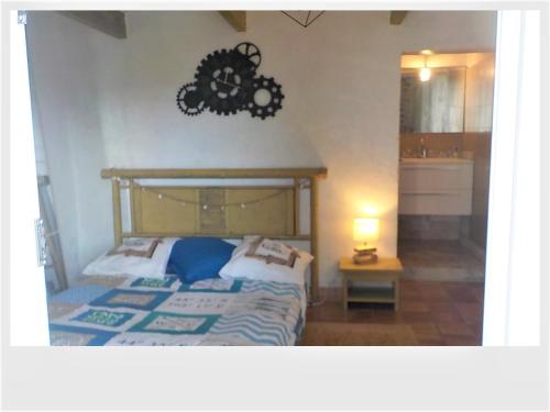 a bedroom with a bed and a clock on the wall at FRAROCKA B and B in La Ciotat