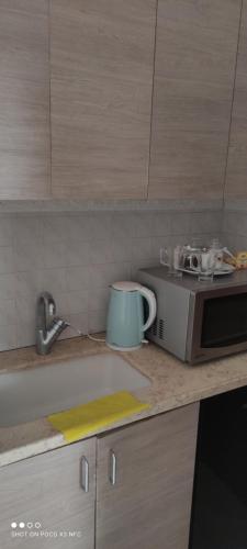 a kitchen counter with a microwave and a mug on it at Apartment with terrace and parking in Eilat