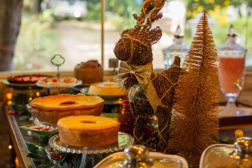 a table with cakes and other desserts on it at Pousada da Leide in Fernando de Noronha