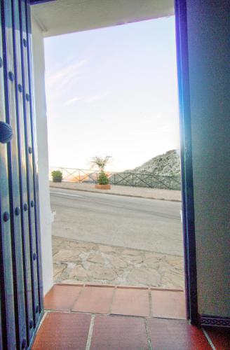 an open door with a view of a road at Con el Alma in Benaocaz