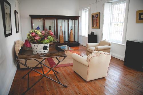 a living room with a table with flowers on it at EpiStay in Tulbagh