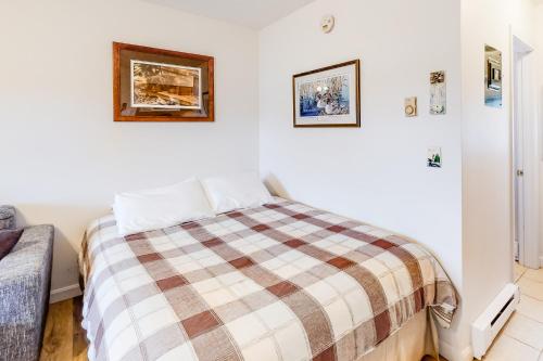 a bedroom with a bed with a plaid blanket at Loon Nest in Rockwood