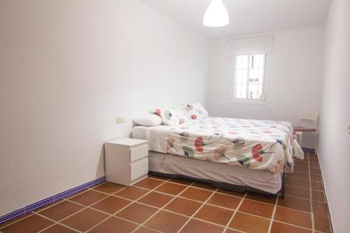 a small bedroom with a bed and a window at Con el Alma in Benaocaz