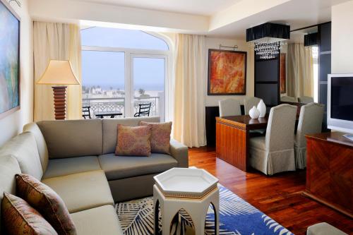 a living room with a couch and a television at Wyndham Garden Salalah Mirbat in Salalah