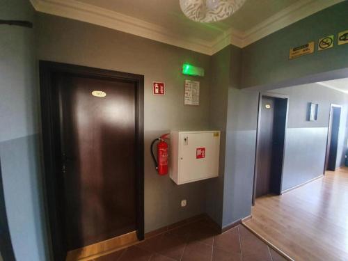 a hallway with a fire extinguisher on a wall at Lux Resort in Kraśnik