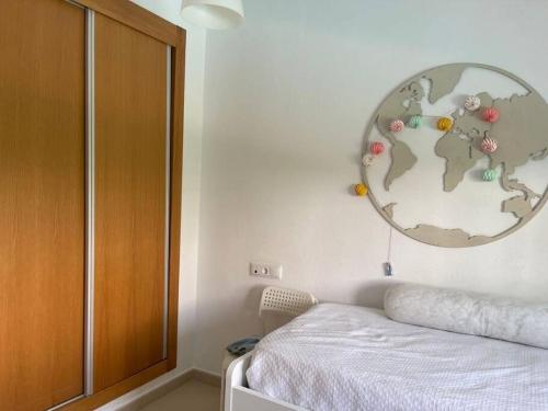 a bedroom with a globe on the wall next to a bed at Fantastica villa con piscina en gran golf resort in Roldán