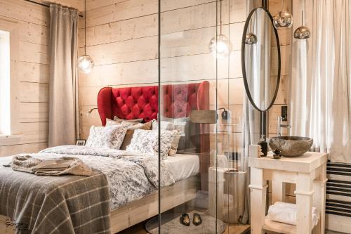a bedroom with a bed with a red headboard at Luxury Chalet Villa Gorsky Hanco & Janso in Poronin