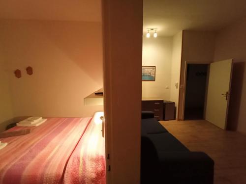 a bedroom with a bed and a couch in a room at La Casa della Nonna in Brisighella
