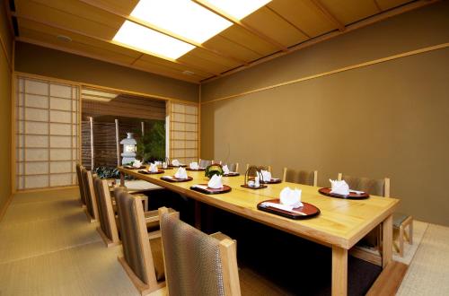a dining room with a long table and chairs at Lao Plaza Hotel in Vientiane
