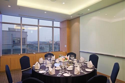 a conference room with a table and chairs and a large window at Holiday Inn Gwangju by IHG in Gwangju