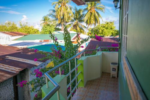 a view from the balcony of a house with a swimming pool at Mikado Surf Camp in Thimarafushi