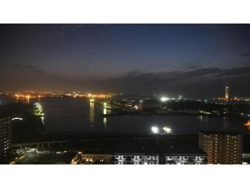 a view of a city at night with the water at The QUBE Hotel Chiba - Vacation STAY 02227v in Chiba