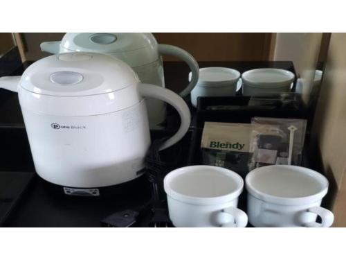 a kitchen counter with a coffee maker and cups at The QUBE Hotel Chiba - Vacation STAY 02241v in Chiba