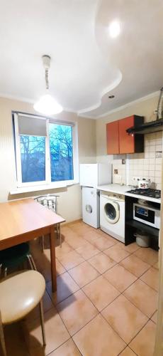 a kitchen with a table and a stove top oven at 2 кімн. кв. "Романтік" in Cherkasy