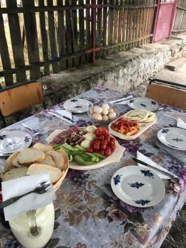 a table with plates of food on it at Casuta Bunicilor Isverna in Isverna