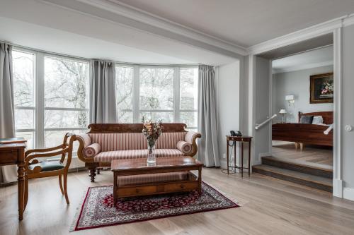 a living room with a couch and a table at Söderköpings Brunn in Söderköping