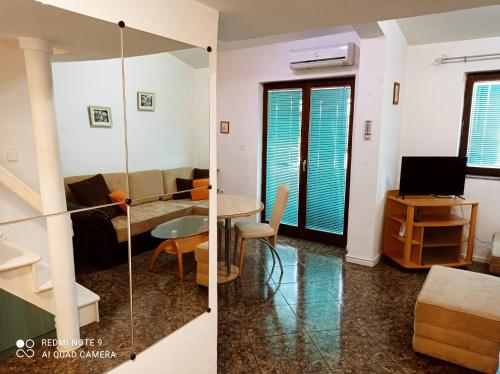 a living room and a dining room with a table at OHRID LOFT : The Den in Ohrid