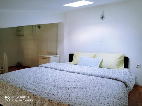 a bedroom with a large bed with white pillows at OHRID LOFT : The Den in Ohrid