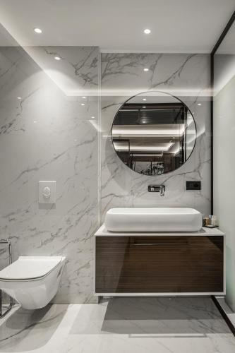 a bathroom with a white sink and a mirror at Hotel MANAMI in Pristina