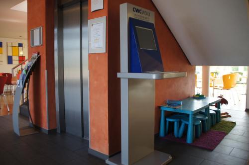 a room with a table and a stairwell with an exhibit at EuroHotel Günzburg in Günzburg