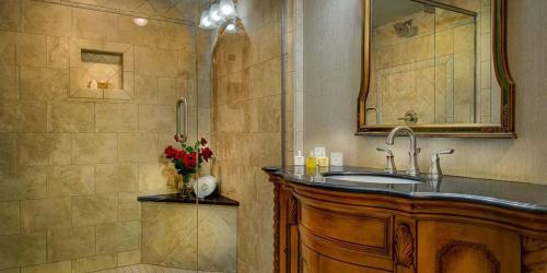 a bathroom with a sink and a shower at Red Coach Inn in Niagara Falls