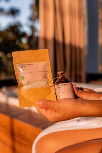 a person holding a box with a bottle of medicine at Morada Reino Encantado in São Joaquim