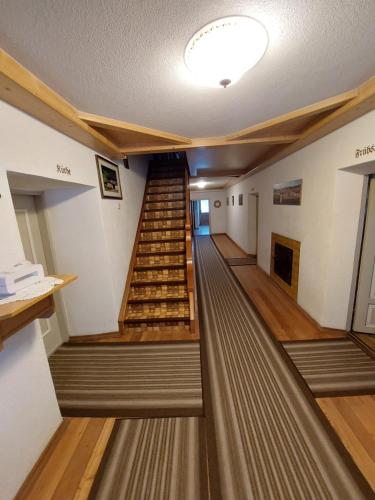 a long hallway with stairs in a building at Ferienhaus Köck in Kartitsch