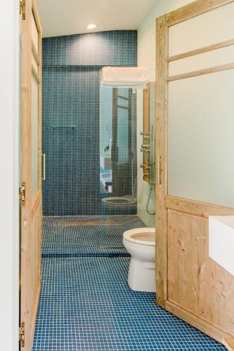 a bathroom with a toilet and a glass shower at The Frenchie in Round Top