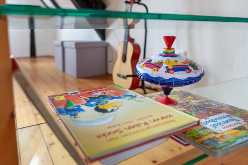 a cake on a table with a book and a vase at Fachwerkhäuschen in Enkirch