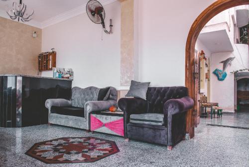 a living room with two couches and a table at Gina Motel Dahab in Dahab