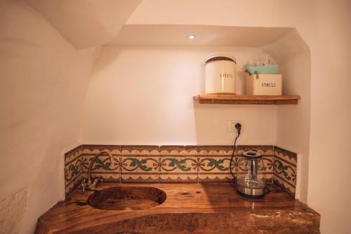a bathroom with a wooden sink and a shelf at Via Roma 32 in Ostuni