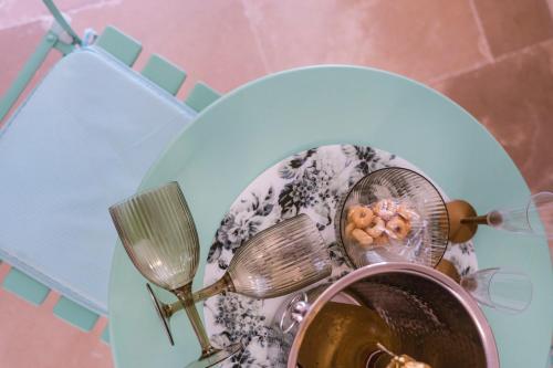 a plate with two straining utensils and a bowl of food at Via Roma 32 in Ostuni