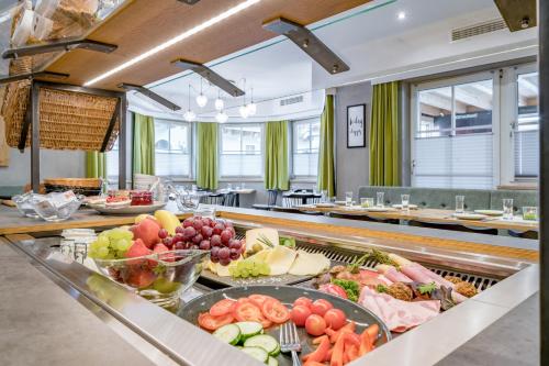 
a kitchen filled with lots of fruits and vegetables at Arlen Lodge Hotel in Sankt Anton am Arlberg
