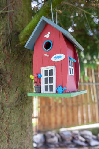 a bird house hanging from a tree at Fachwerkhäuschen in Enkirch