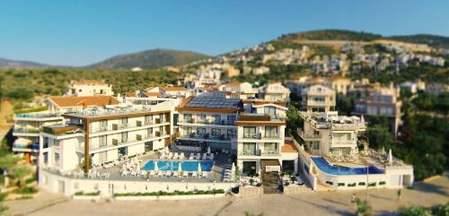 a group of buildings on a hill with a mountain at Rhapsody Hotel & Spa Kalkan in Kalkan