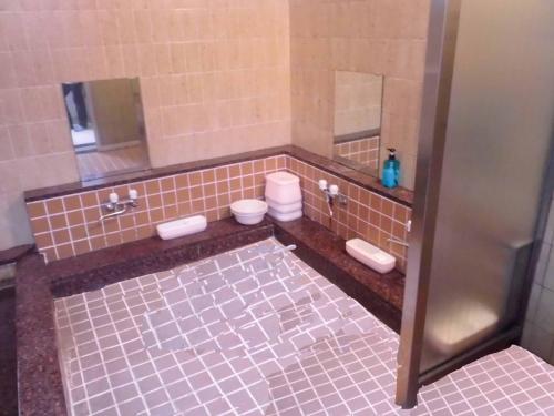 a bathroom with two sinks and two toilets at Park Inn in Osaka