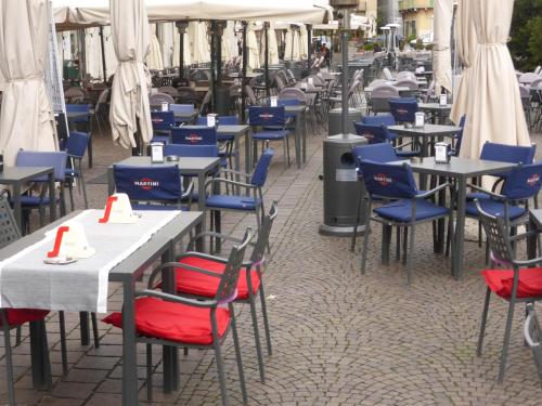 a row of tables and chairs in a restaurant at Galleria d'Arte - Foresteria in Brescia