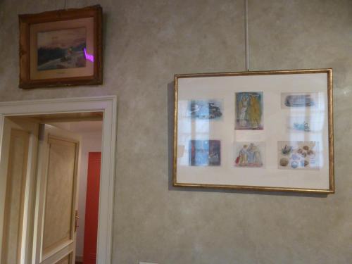 a picture hanging on a wall with a picture at Galleria d'Arte - Foresteria in Brescia